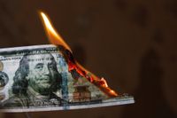 $100 bill that has been set on fire